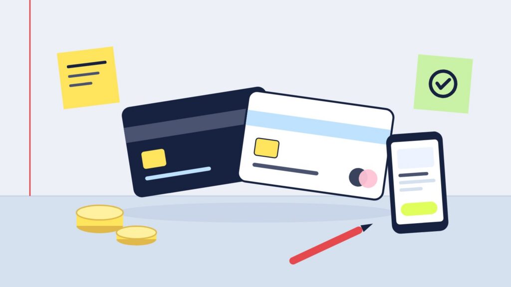 Illustration : deux cartes bancaires, un téléphone ouvert sur une application de compte, des pièces et deux post-it sur un bureau